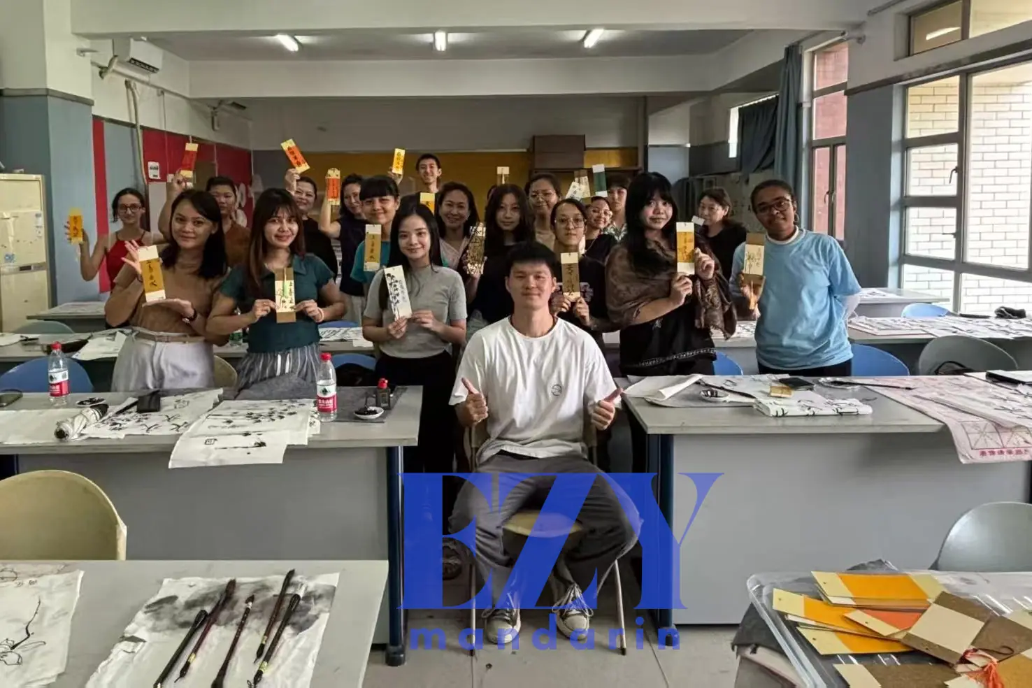 A participant practicing Chinese calligraphy with brush and ink